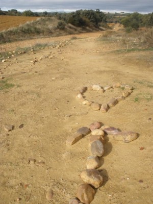 A pilgrim on the Camino has marked the way with an arrow pointing towards a heart. Things of the heart are ahead.